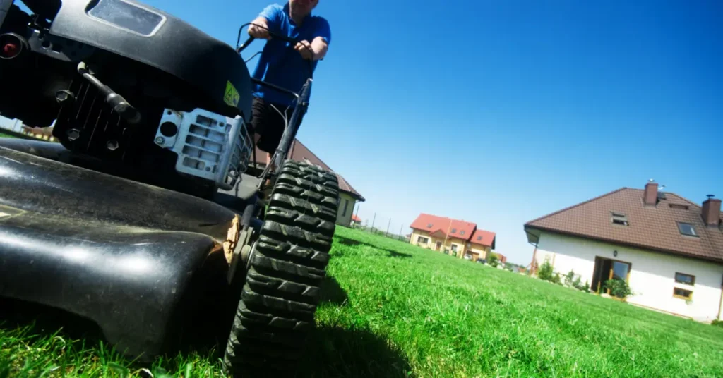 A lawn mower cutting grass, indicating yard work or maintenance. Teen is earning money as he starts budgetting for teens.