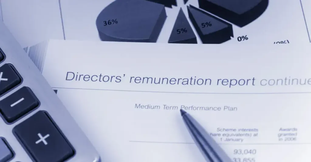 A close-up of a financial report document with a calculator and pen, indicating data analysis or review. It is a part of the finance director jobs to crate them.