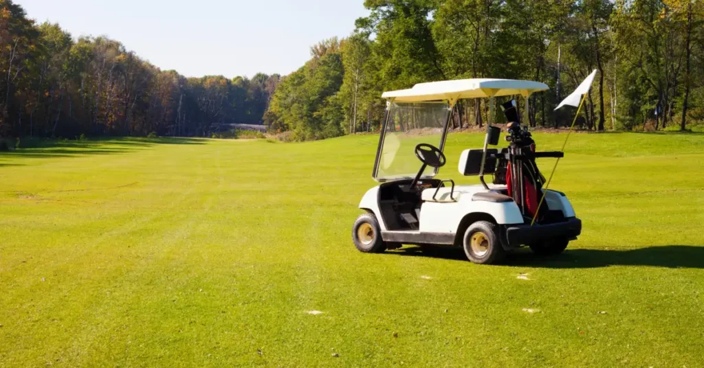 A parked golf cart with a set of golf clubs on a sunny golf course. Get yours now, start by golf cart financing