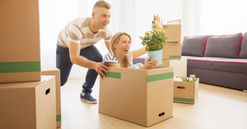 A couple is having fun while unpacking boxes, indicating moving to a new home. What Are Some Key Components of Successful Budgeting?